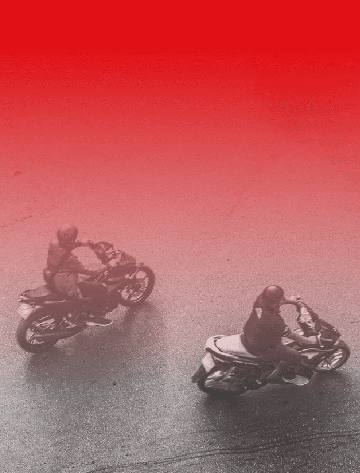 Two people riding motorcycles.